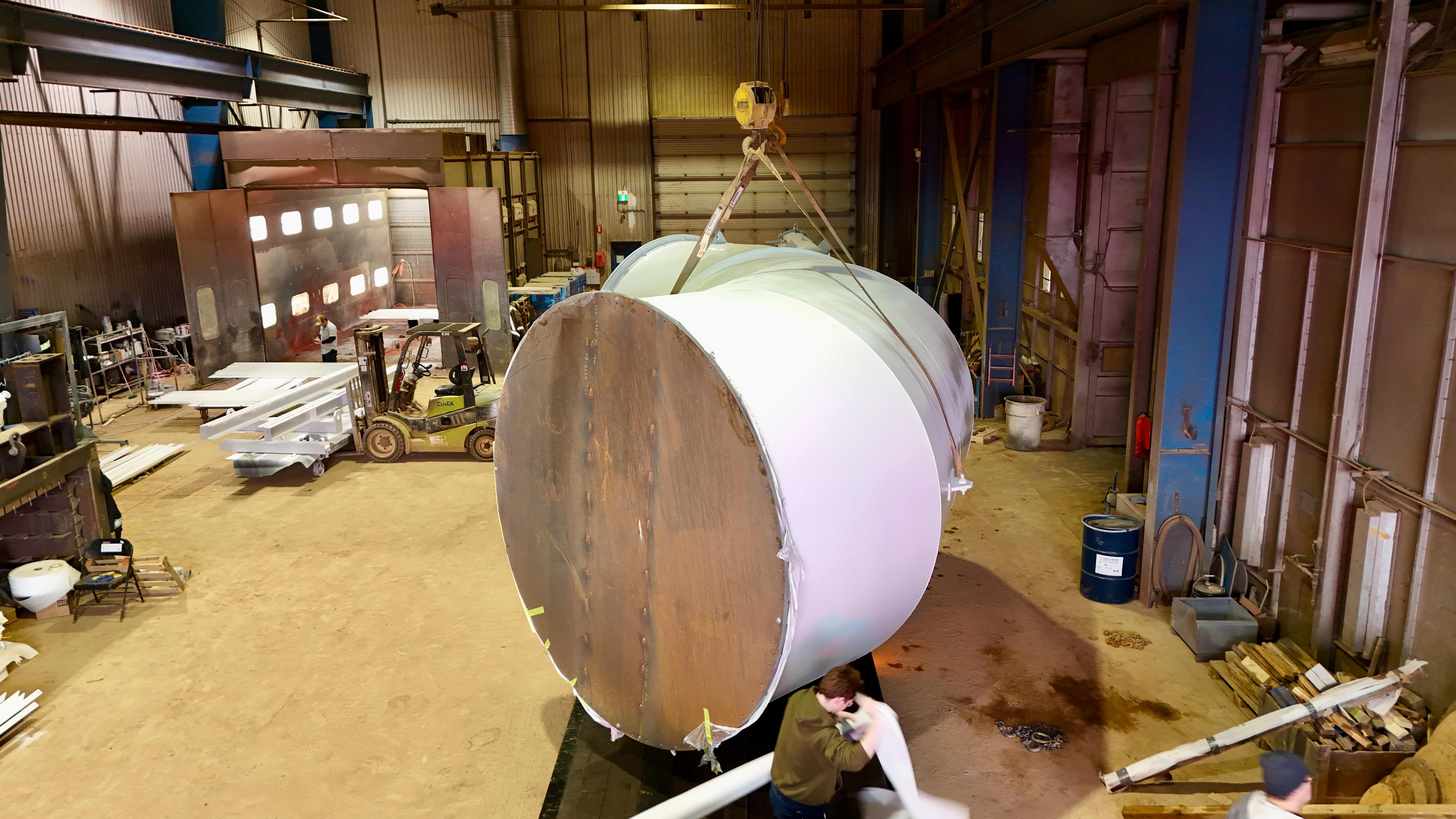 Crane lifting industrial vessel